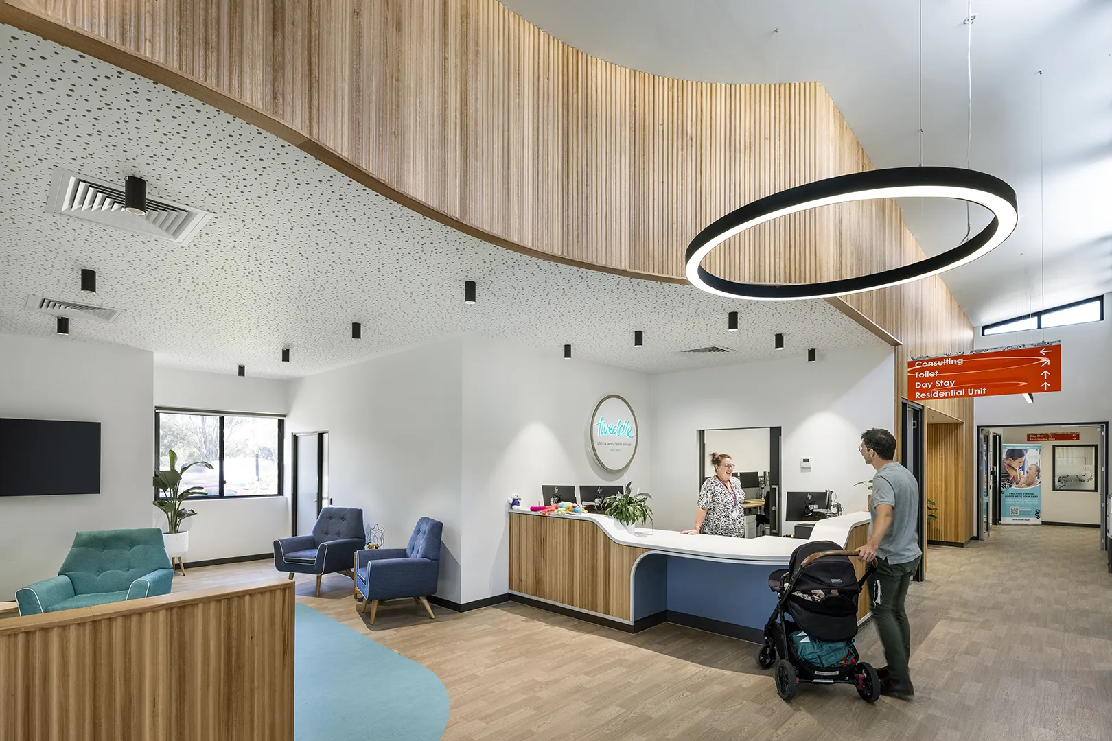 Reception area with a welcome desk, comfortable seating, and clear wayfinding for families visiting the centre.