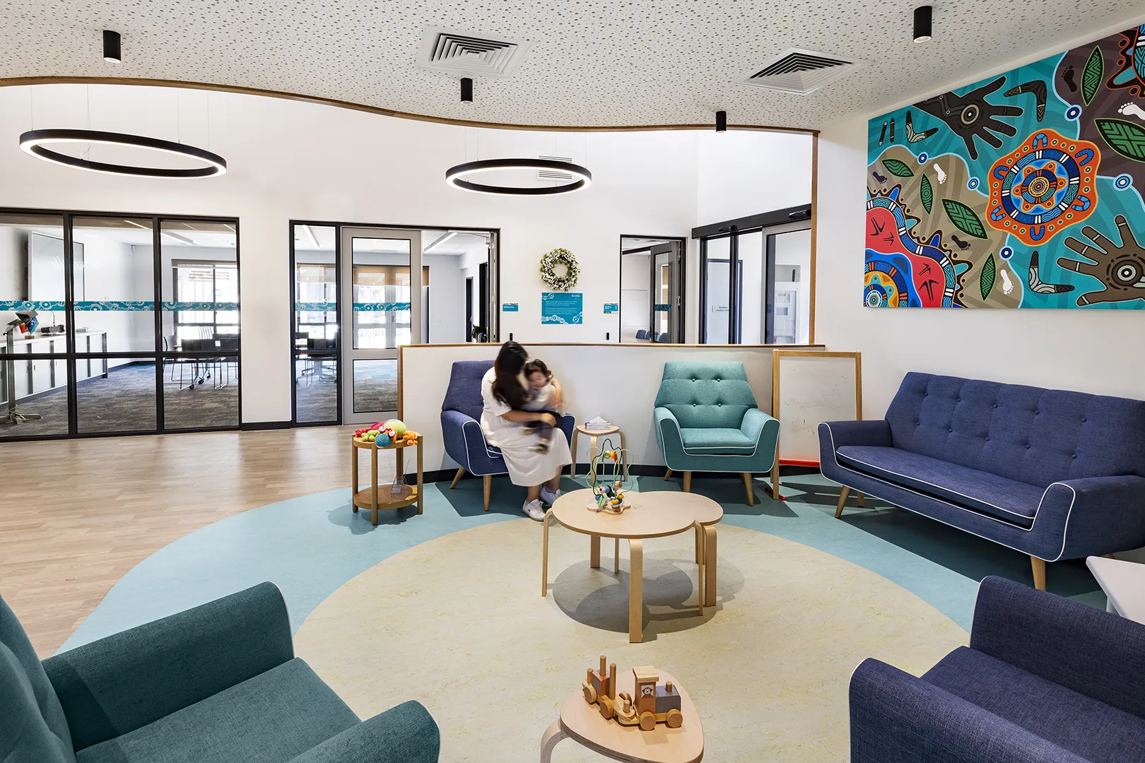 Family lounge with comfortable seating, children's play activities, and flexible spaces for parents and young children.