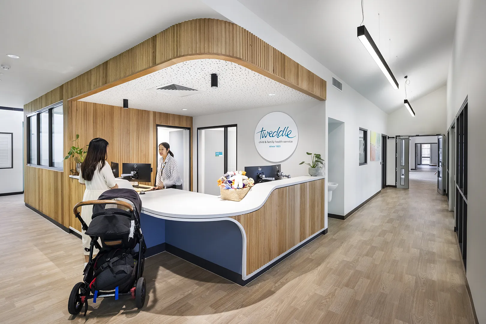 Reception desk with welcoming staff, clear wayfinding, and family-friendly facilities at the centre entrance.