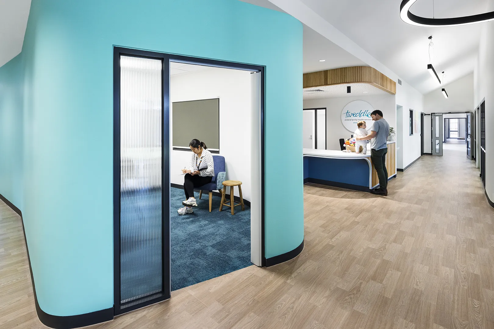 Consultation room with private seating, natural light, and reception services nearby for families accessing support and care.