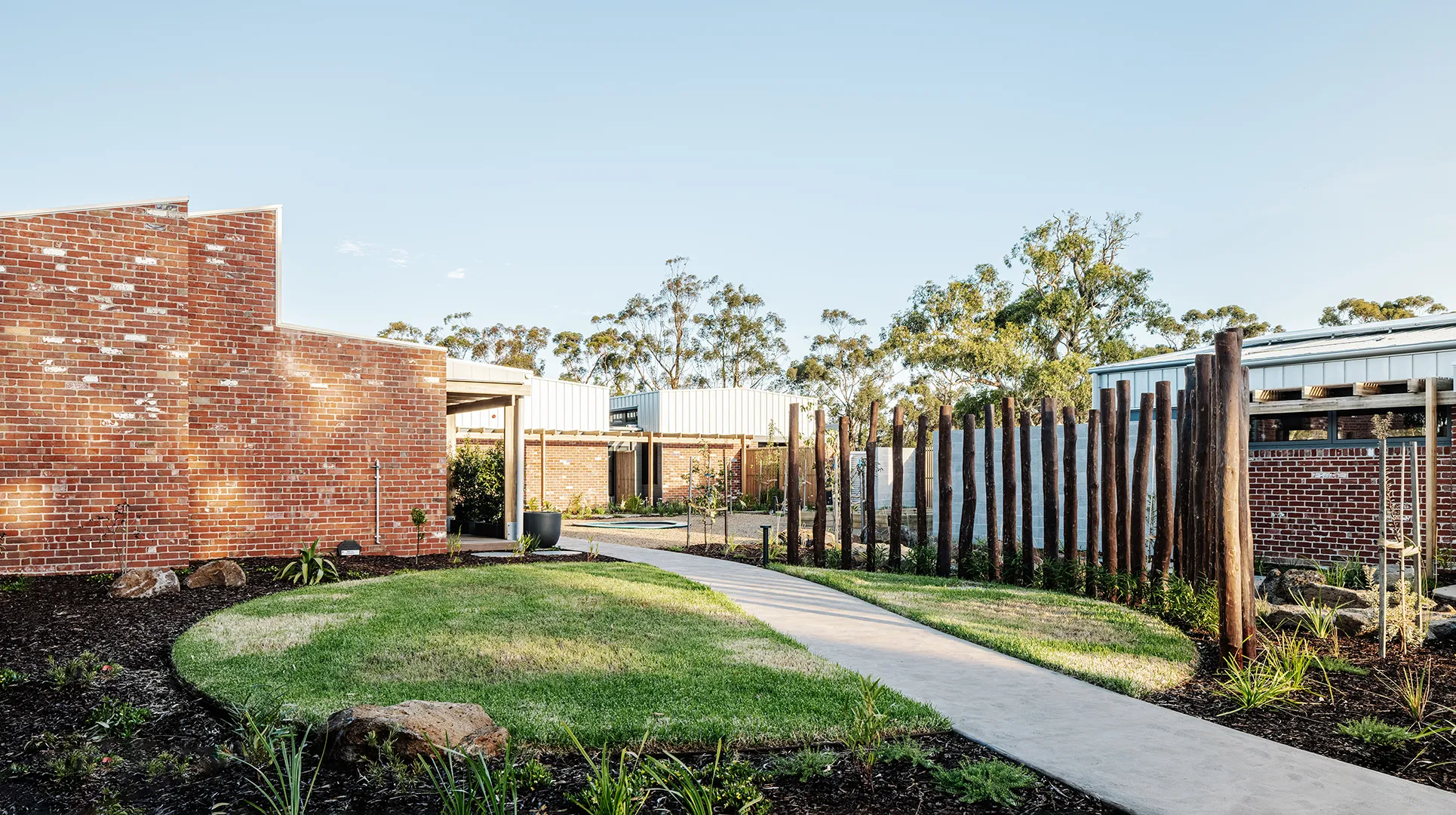 Landscaped communal garden with accessible pathways, lawn areas, and outdoor spaces for recreation and relaxation.