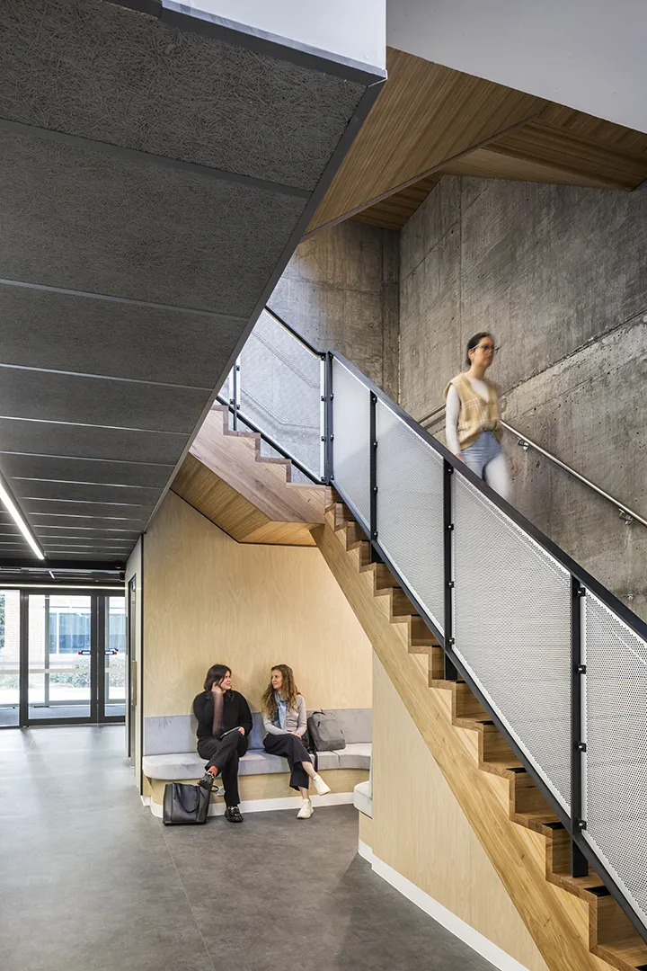 Stairway and shared seating area providing spaces for informal meetings, study, and movement throughout the building.
