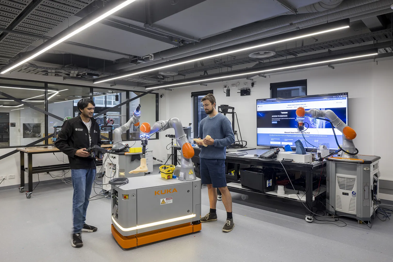 Researchers working with robotics equipment in a laboratory designed for technology development, testing, and innovation.