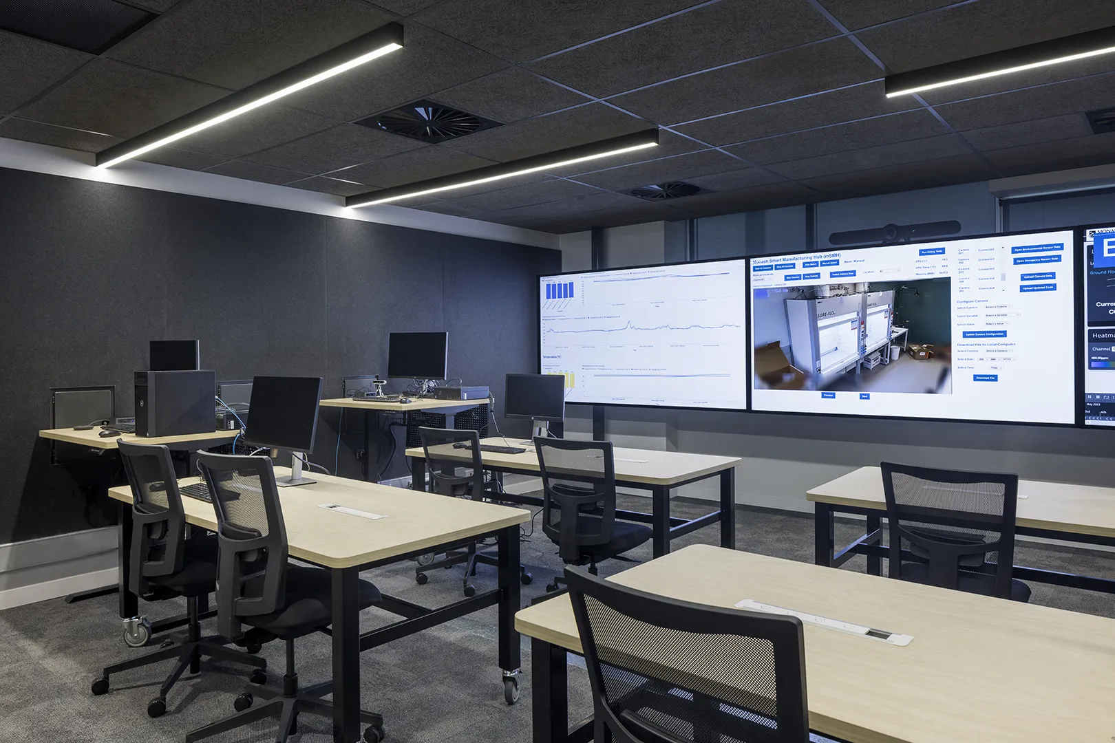 Technology training room with computer workstations, large display screens, and flexible spaces for teaching, research, and collaboration.