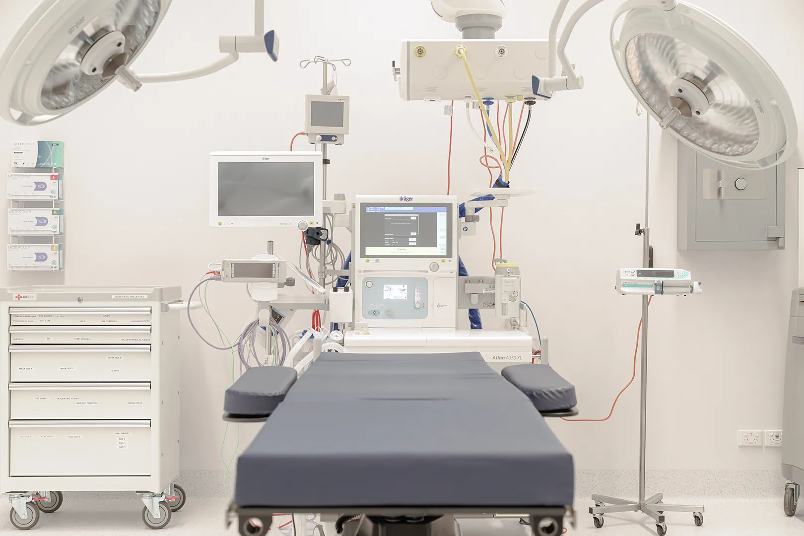 Advanced procedure suite with surgical lighting, patient table, anaesthetic equipment, and specialist monitoring systems.