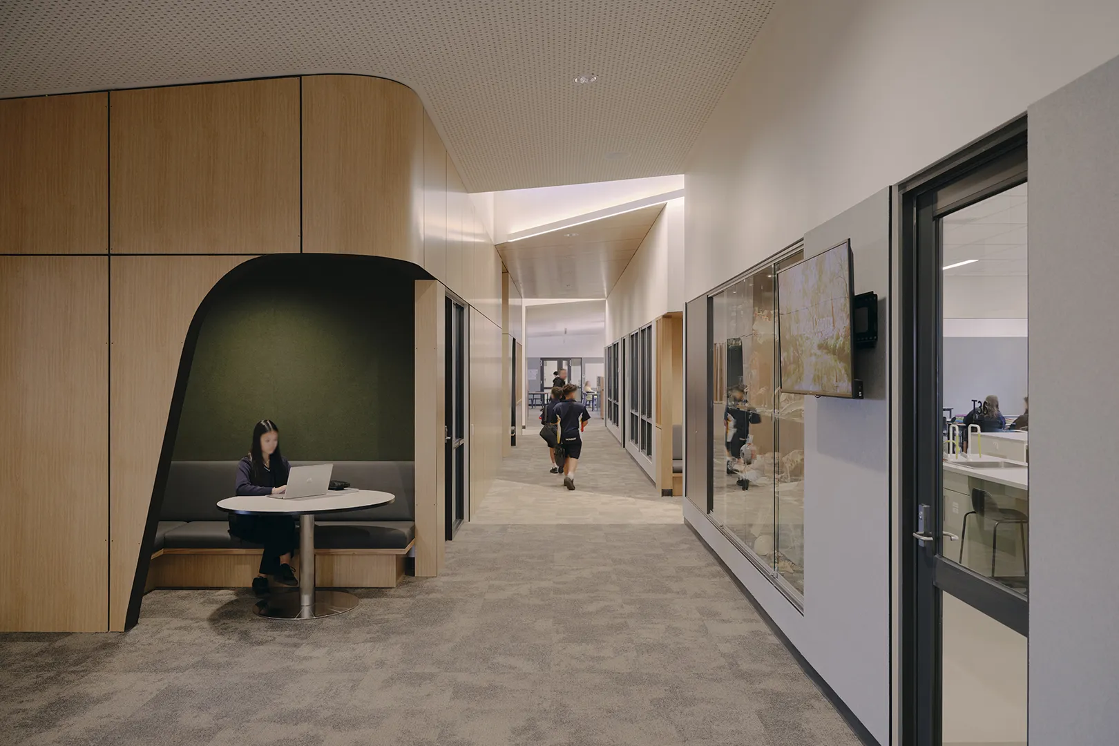 Student using a quiet study booth within a learning area connected to classrooms, laboratories, and collaborative spaces.