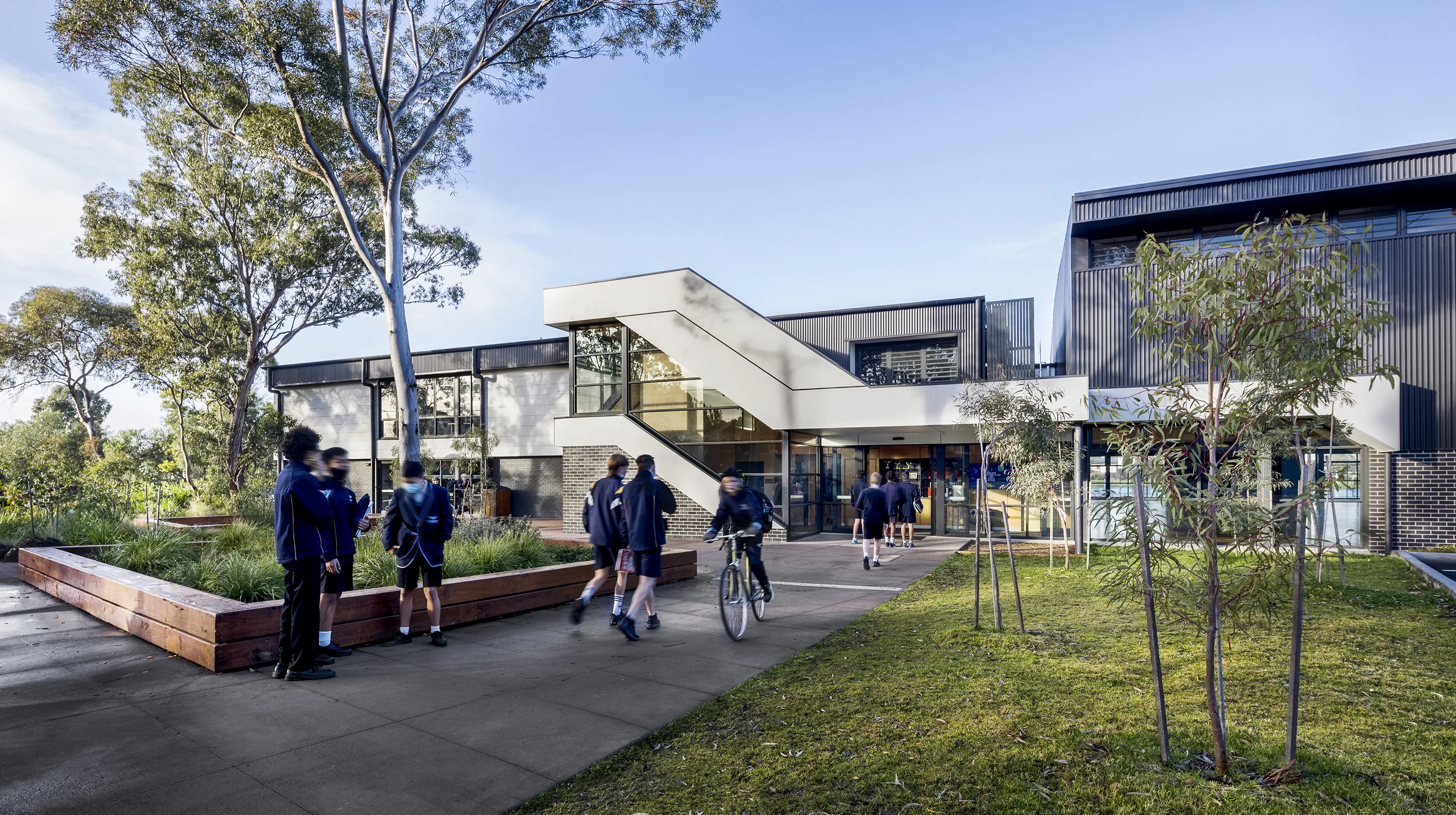 Thornbury High School Sports Hall and Performing Arts Centre with landscaped outdoor spaces, student activity, and a welcoming campus entrance.