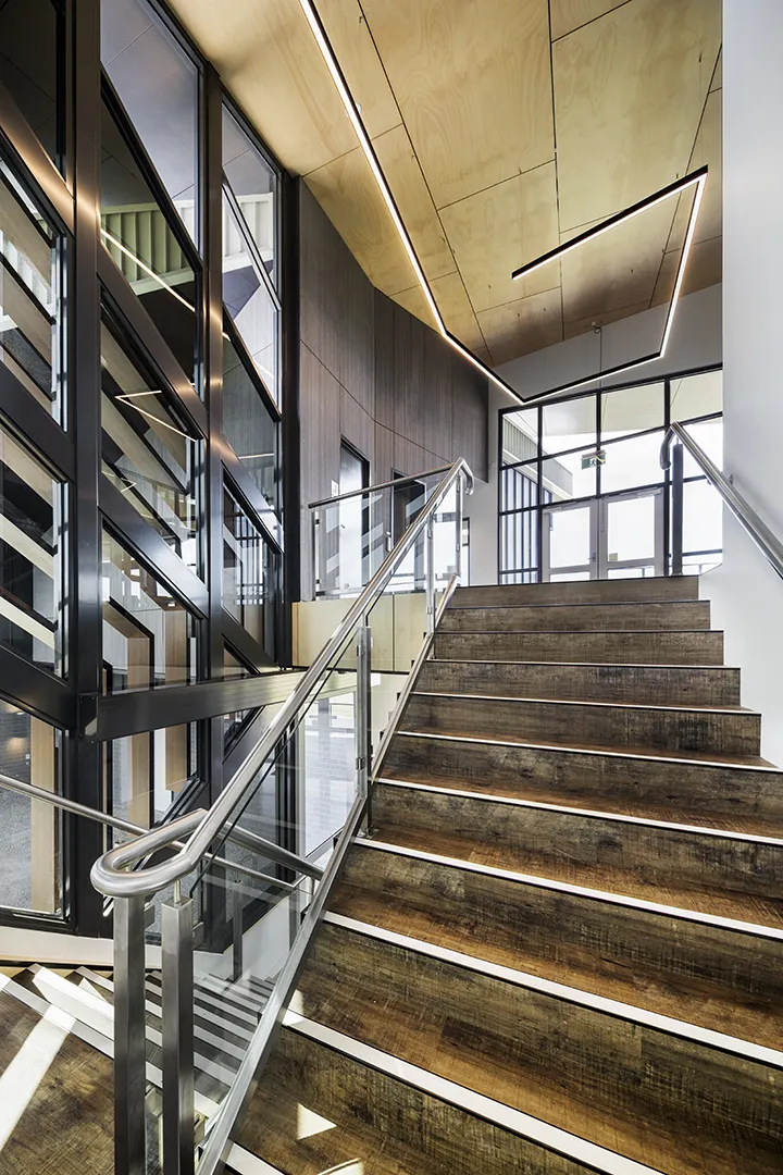 Main internal stairway with open circulation areas, large windows, and access to community and spectator facilities.
